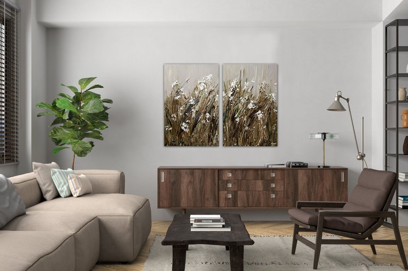 May include: A split canvas wall art featuring a close-up of a field of tall grasses and white flowers in shades of brown, beige, and white.