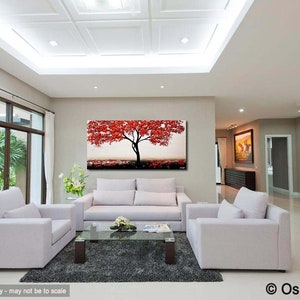 May include: A living room interior design with a large abstract painting of a red tree on a white wall. The painting is above a white sofa with two white armchairs. The room has a white ceiling with recessed lighting and a large window with white curtains.