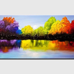 May include: A colorful abstract painting of a forest reflecting in a still lake. The trees are painted in shades of purple, blue, green, yellow, orange, and red. The lake is a deep blue with reflections of the trees in shades of purple, blue, green, yellow, orange, and red.