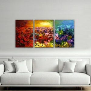 May include: A three-piece abstract art print set featuring a field of colorful flowers. The first panel is red and orange, the second is yellow and orange, and the third is blue and green.