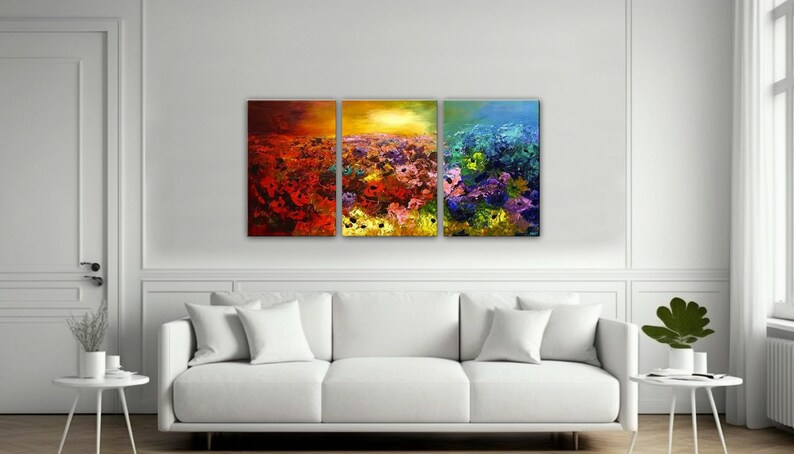 May include: A three-piece abstract art print set featuring a field of colorful flowers. The first panel is red and orange, the second is yellow and orange, and the third is blue and green.