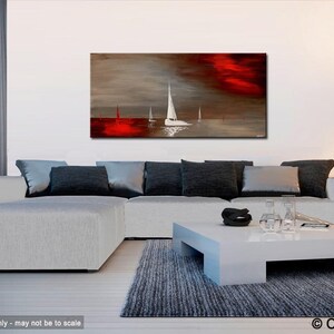 May include: Abstract painting of sailboats on a body of water with a red and gray sky. The painting is displayed on a wall above a white couch and coffee table.