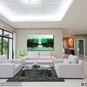 May include: A living room interior design with a large abstract landscape painting in teal, green, and blue hues hanging on the wall above a white sofa. The painting depicts a lake with trees reflected in the water. The room has a white tiled floor and white furniture.