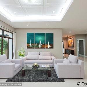 May include: A three-piece abstract painting of sailboats on a teal and blue ocean with a sunset in the background. The painting is hanging on a wall in a living room with white furniture.