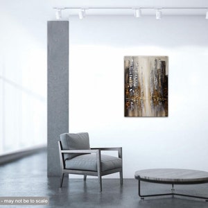 May include: Abstract painting of a city skyline in shades of gray, brown, and gold. The painting is displayed on a white wall in a modern living room setting.