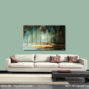 May include: Abstract painting of a forest scene with trees in shades of blue, green, and brown. The trees are silhouetted against a white sky with a bright light shining through the branches. The painting is displayed on a white wall above a white couch with brown pillows.