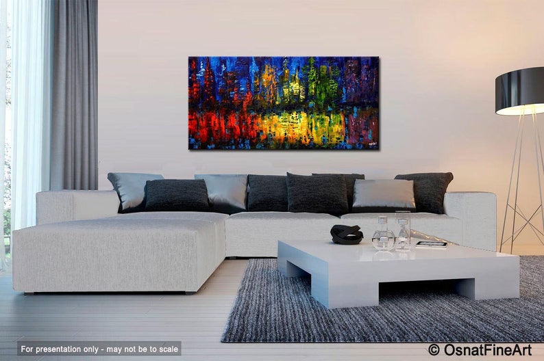 May include: Abstract painting with vibrant colors, including red, yellow, green, and blue, in a modern living room setting with a white sofa and a white coffee table.