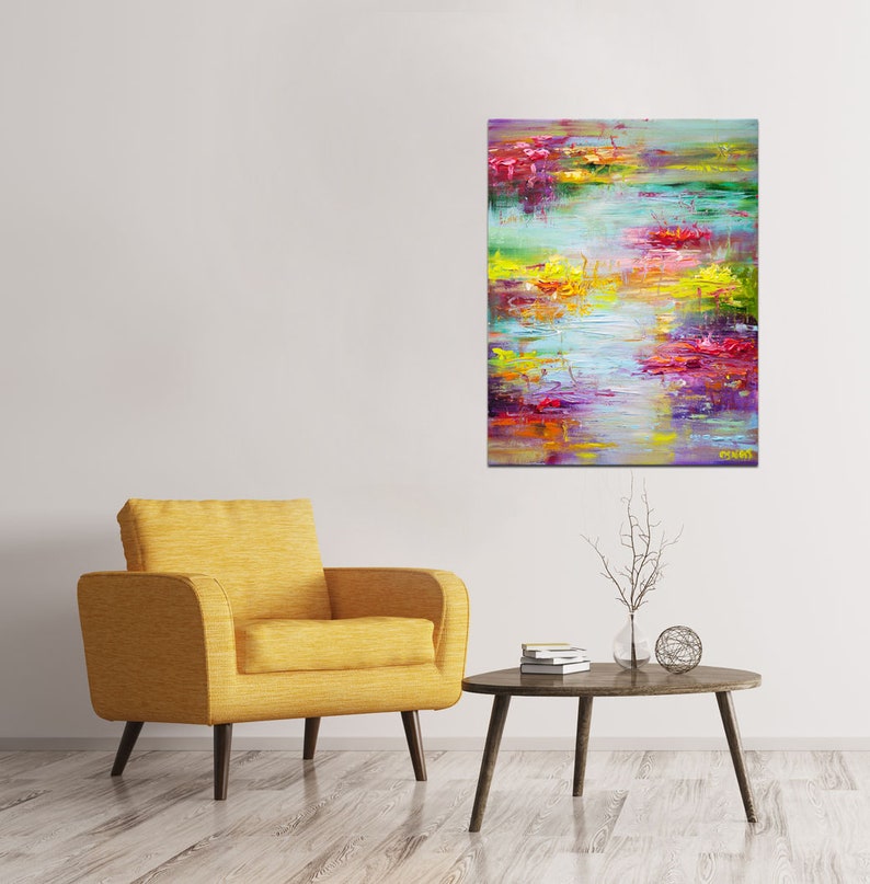 May include: Abstract painting with vibrant colors, including pink, purple, yellow, and green. The painting has a textured, brushstroke effect and depicts a landscape with water and flowers.