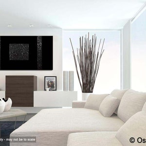 May include: Black and white abstract painting with a textured surface. The painting is hanging on a white wall in a modern living room with a white couch and a vase of brown branches.