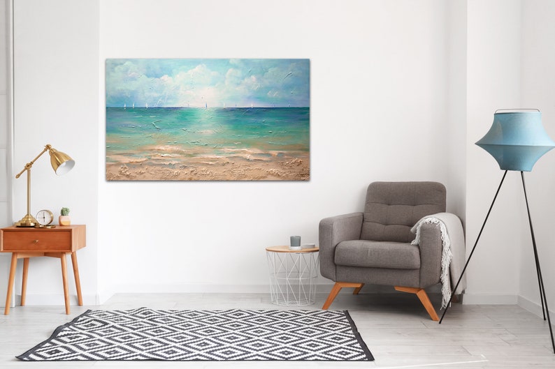 May include: A painting of a seascape with a sandy beach, turquoise water, and a bright blue sky with white clouds.  Sailboats are visible in the distance.