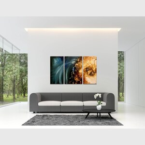May include: A three-piece abstract art print set featuring a blue and green swirl on the left, a brown and gold swirl in the middle, and a brown and gold swirl on the right. The prints are displayed on a white wall above a gray couch in a modern living room.