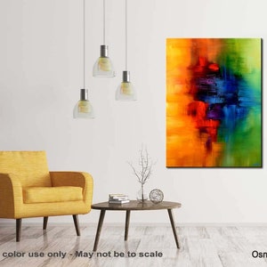 May include: Abstract painting with vibrant colors of yellow, orange, red, blue, green, and purple. The painting is on a canvas and is framed. The painting is hanging on a white wall in a living room setting.