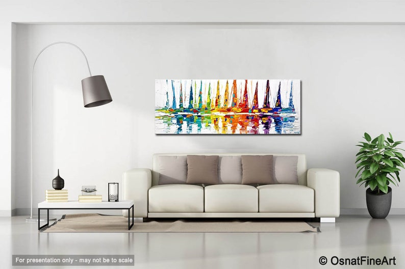 May include: Abstract painting of colorful sailboats on a body of water with reflections. The painting is in a modern living room setting with a white couch and a floor lamp.