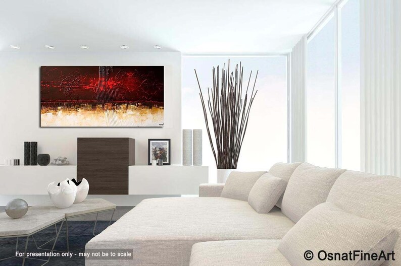 May include: Abstract painting with red, brown, and gold hues. The painting is displayed on a white wall in a modern living room setting with a white couch and a vase of brown branches.