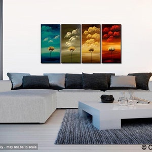 May include: A four-panel abstract painting depicting a stylized tree with a yellow trunk and green, blue, yellow, and red foliage against a background of clouds. The painting is displayed in a living room setting with a white sofa, a white coffee table, and a black floor lamp.