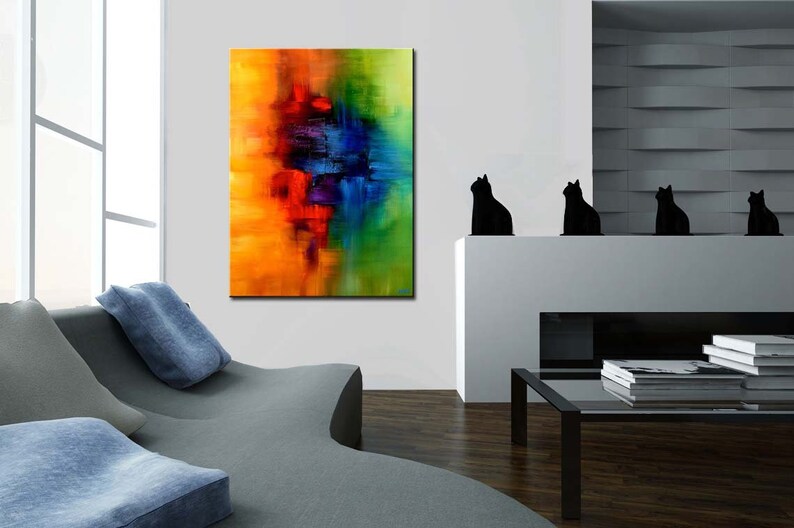 May include: Abstract painting with vibrant colors of yellow, orange, red, blue, and green. The painting is displayed on a white wall in a modern living room setting.