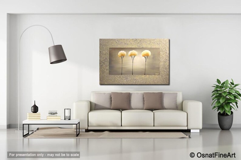 May include: A painting of three stylized trees with yellow flowers against a light brown background. The painting is framed in a gold frame with a textured surface.