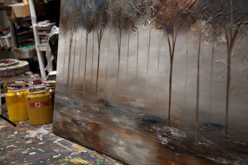 May include: Abstract painting of a forest scene with trees in the foreground and a hazy background. The painting is done in shades of brown, gray, and white.