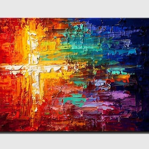 May include: Abstract painting with a white cross shape in the center. The background is a mix of red, orange, yellow, green, blue, and purple.