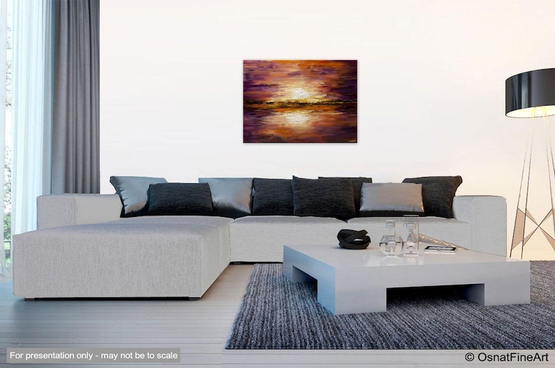 May include: A painting of a sunset over a body of water. The sky is a mix of purple, orange, and yellow. The water is a deep blue with reflections of the sunset.