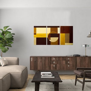 May include: Abstract art print in three panels featuring geometric shapes in shades of brown and yellow. The center panel features a large circle.
