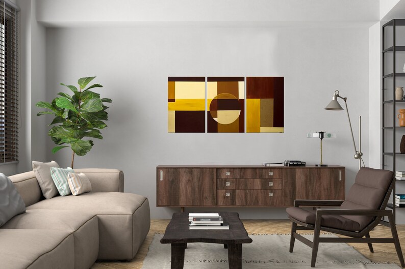 May include: Abstract art print in three panels featuring geometric shapes in shades of brown and yellow. The center panel features a large circle.