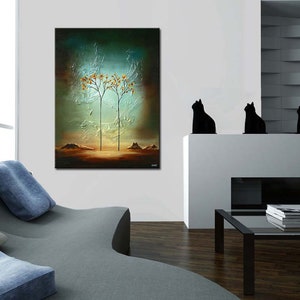 May include: Abstract painting of two trees with orange leaves against a blue and green background. The painting is hanging on a white wall in a modern living room with a gray couch and a black coffee table.