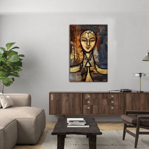May include: Abstract painting of a person's face with a gold and brown background. The painting is framed and hanging on a wall in a living room.