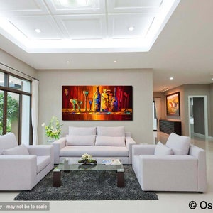 May include: A colorful abstract painting of bottles and glasses on a bar counter. The painting is in a modern living room with white couches and a coffee table.