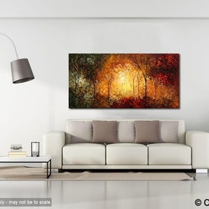 May include: A painting of a forest scene with trees in shades of green, yellow, orange, and red. The trees are illuminated by a bright light in the center of the painting. The painting is displayed on a white wall in a living room setting.