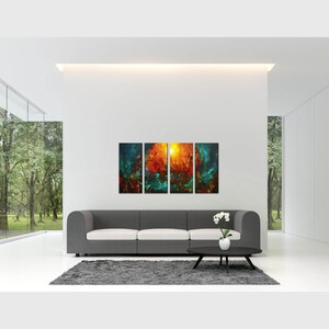 May include: A modern living room with a gray sofa and a coffee table. The wall behind the sofa features a three-panel abstract art piece with shades of blue, green, orange, and yellow.