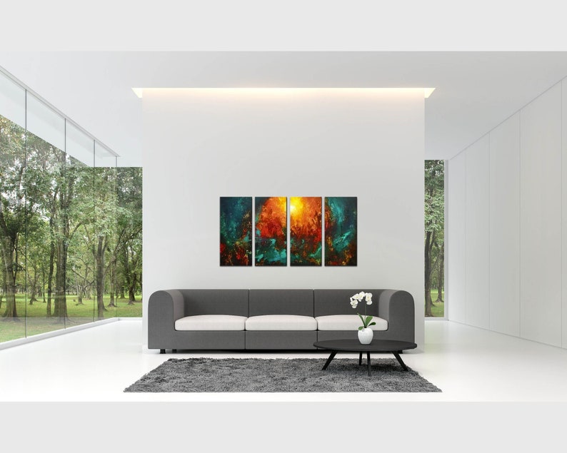 May include: A modern living room with a gray sofa and a coffee table. The wall behind the sofa features a three-panel abstract art piece with shades of blue, green, orange, and yellow.