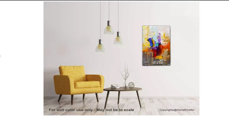 May include: Abstract painting with bold strokes of yellow, orange, red, blue, purple, and gray. The painting is hanging on a white wall in a living room setting with a yellow armchair and a coffee table.