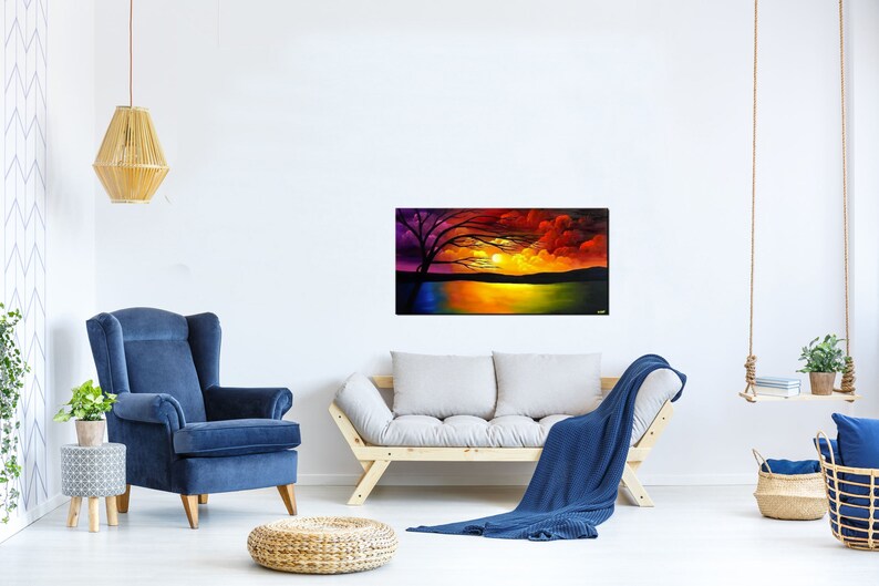 May include: A colorful painting of a sunset over a lake with a silhouetted tree in the foreground. The sky is a mix of red, orange, yellow, and purple. The lake is a deep blue with reflections of the sunset.