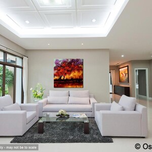 May include: A living room interior with white furniture, a large painting of a colorful tree, and a glass coffee table. The painting is a vibrant mix of red, orange, yellow, and purple.