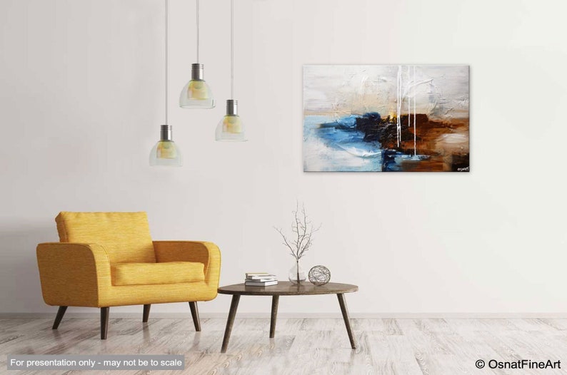 May include: Abstract painting with blue, brown, and white colors. The painting is hanging on a white wall above a yellow armchair and a coffee table with a small tree branch in a vase.