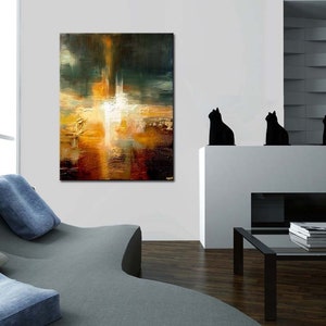 May include: Abstract painting with a mix of warm and cool colors, featuring a central white shape surrounded by shades of orange, yellow, brown, and green. The painting is displayed on a white wall in a modern living room setting.