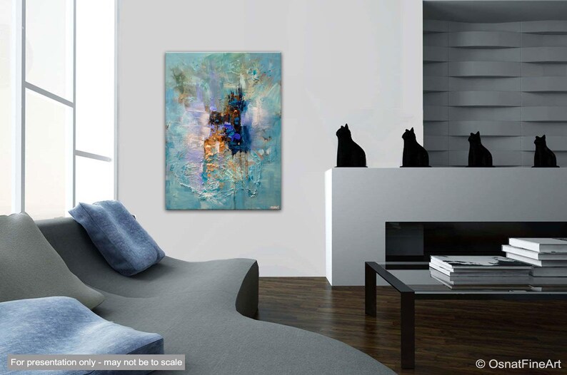 May include: Abstract painting with blue, white, and brown colors. The painting has a textured surface and is displayed on a white wall in a living room setting.
