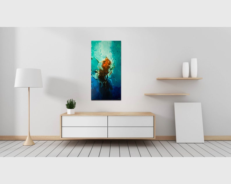 May include: Abstract painting with a blue, green, and orange color scheme. The painting is framed and hanging on a white wall.