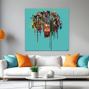 May include: A square canvas art piece featuring a woman's face with closed eyes and a vibrant, colorful hair design. The artwork is set against a teal background, creating a striking contrast. The painting is displayed above a white sofa with colorful pillows.