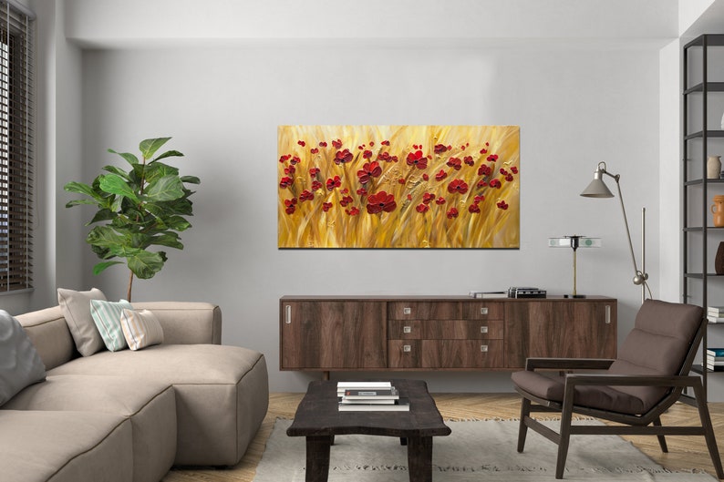May include: A painting of a field of red poppies against a golden background. The painting is displayed on a wall in a living room setting.