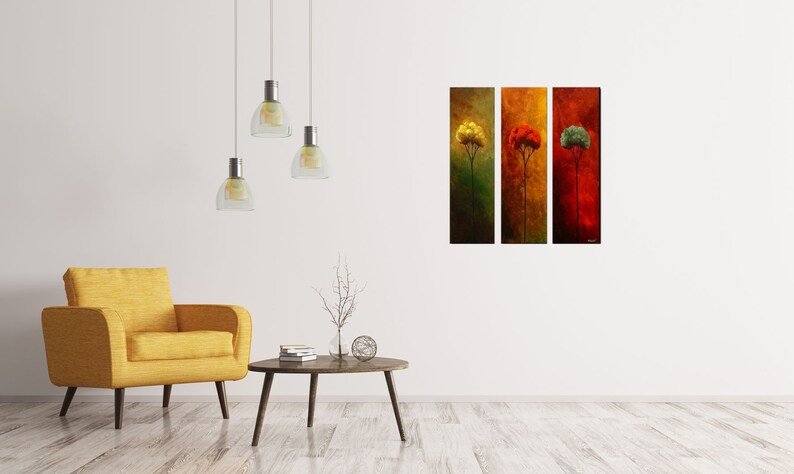 May include: Three vertical canvas prints depicting stylized trees in different colors. The leftmost tree is yellow, the middle tree is red, and the rightmost tree is green. The trees are set against a background of muted brown, orange, and red.