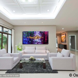May include: Abstract painting in shades of purple, green, and gold, hanging on a wall in a modern living room with white couches and a coffee table.