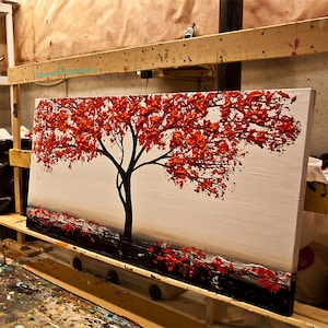 May include: A painting of a red tree with a white background. The tree is painted in a textured style, with thick brushstrokes. The painting is on a canvas and is framed.