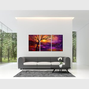 May include: A three-piece abstract painting set depicting a sunset over a purple landscape with a silhouetted tree in the foreground. The painting is in shades of orange, yellow, purple, and black.