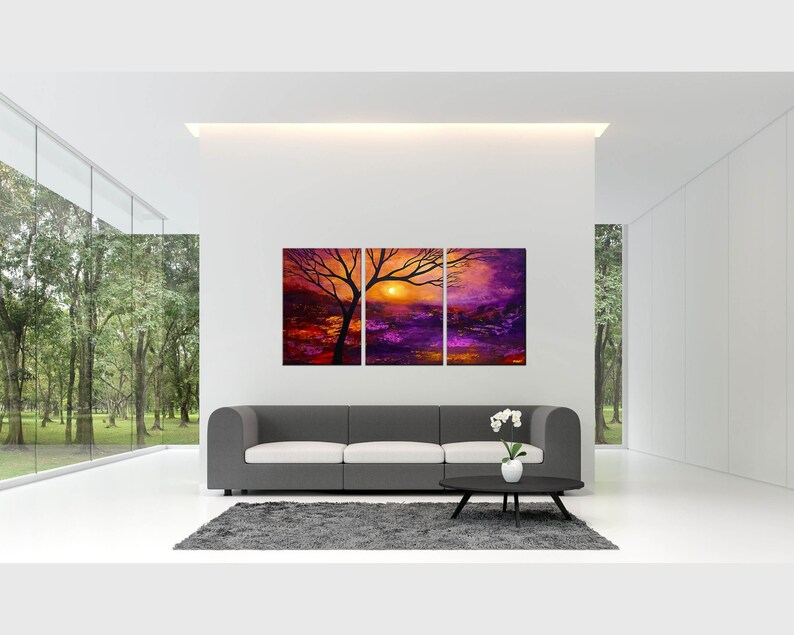 May include: A three-piece abstract painting set depicting a sunset over a purple landscape with a silhouetted tree in the foreground. The painting is in shades of orange, yellow, purple, and black.