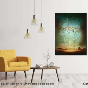 May include: Abstract painting of two trees with yellow leaves against a blue-green background. The trees are silhouetted against a light blue sky. The painting is framed and hanging on a white wall.
