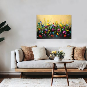 May include: A painting of a field of colorful flowers in shades of pink, purple, yellow, orange, and blue. The flowers are painted in a textured style, giving the painting a three-dimensional effect.