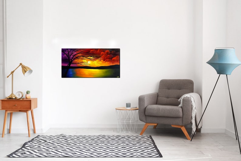 May include: A painting of a colorful sunset over a lake with a silhouette of a tree in the foreground. The sky is a mix of red, orange, yellow, and purple. The lake is a deep blue with reflections of the sunset.