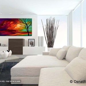 May include: Abstract painting of a tree with a colorful sunset sky in the background. The painting is displayed on a wall in a living room setting with a white couch and a coffee table.